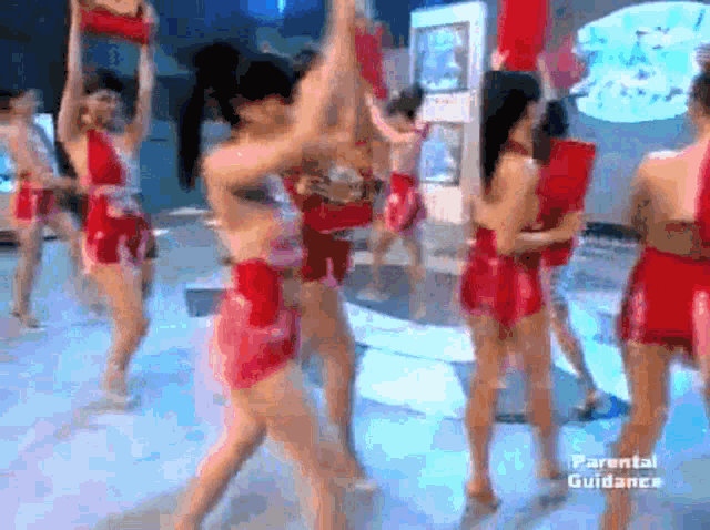 a group of women are dancing on a stage with parental guidelines written on the bottom right