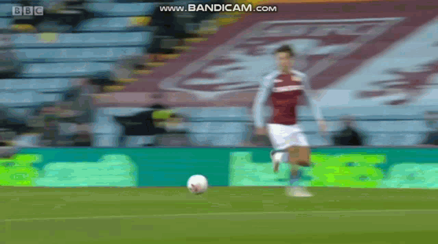 a blurry picture of a soccer player kicking a ball on a field