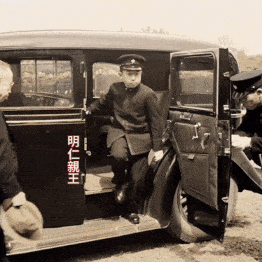 a man is getting out of a car with chinese writing on the door