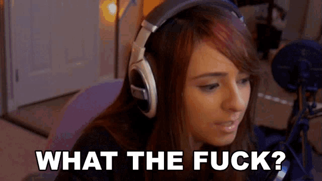 a woman wearing headphones says " what the fuck " in front of a microphone