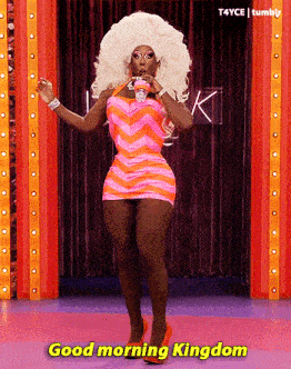 a drag queen says good morning kingdom while dancing on stage
