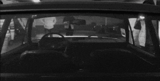 a man in a hat is sitting in a car