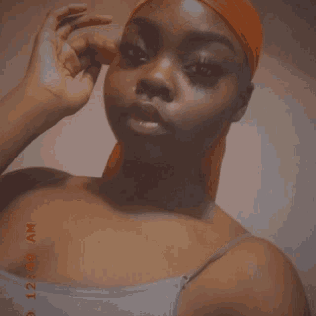a woman 's face is shown with a photo taken at 12:00 am