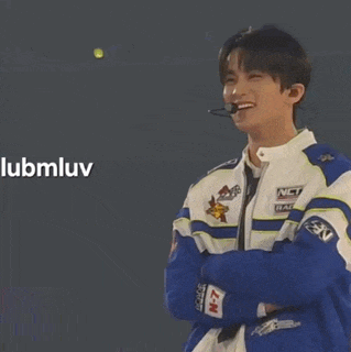 a young man wearing a blue and white jacket with nct on it