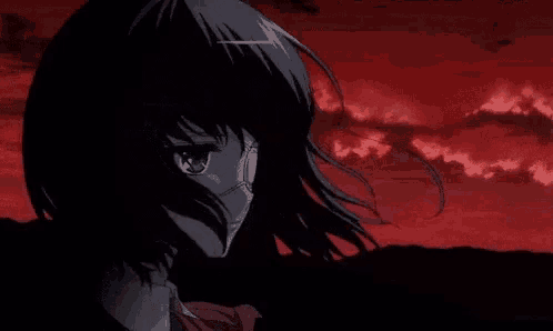 a girl with a mask on her face is standing in the dark .