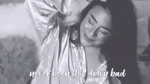 a black and white photo of a woman with the words never been this down bad