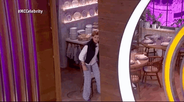 a woman peeking out from behind a wooden wall in a restaurant