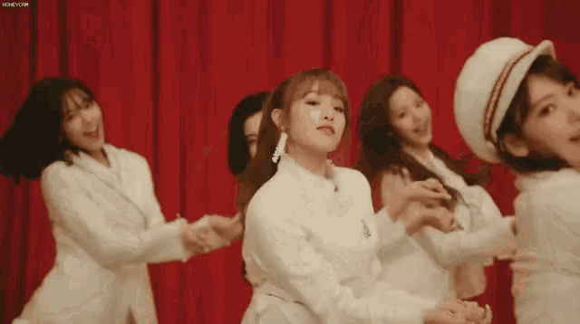 a group of young women are dancing together on a stage .