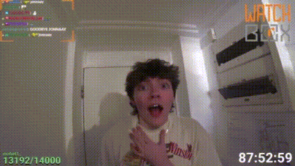a young man is standing in front of a door with his mouth open and his hands in his pockets .