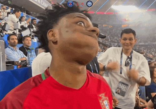 a man making a funny face in front of a scoreboard that says x-0