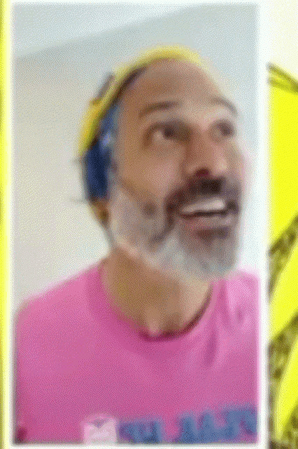 a man with a beard is wearing a pink shirt that says ' nct ' on the front