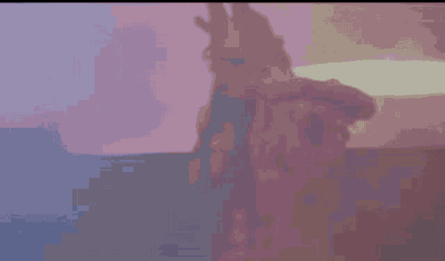 a blurred image of a person in a red costume holding a microphone .