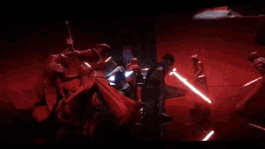 a group of people holding swords in a dark room with a light coming from the right