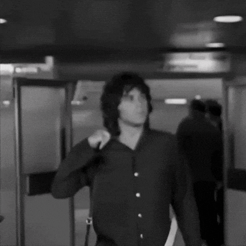 a black and white photo of a man walking