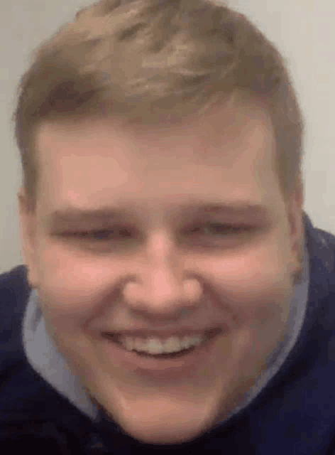a close up of a man 's face with a smile on his face
