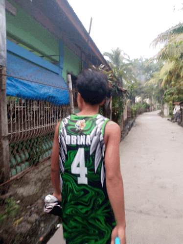 a man wearing a green jersey with the number 4
