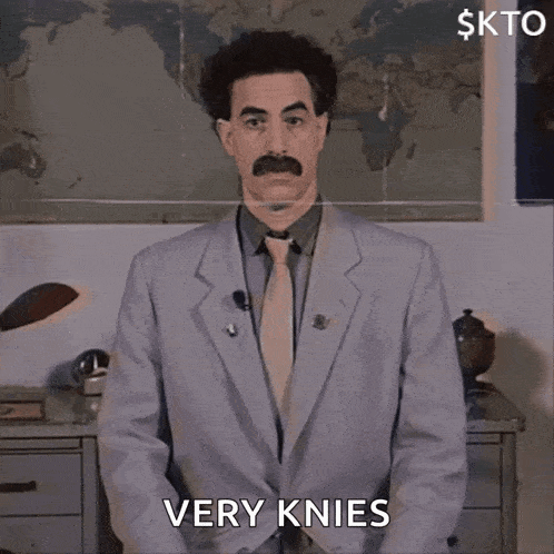 a man in a suit and tie says very knees in front of a map