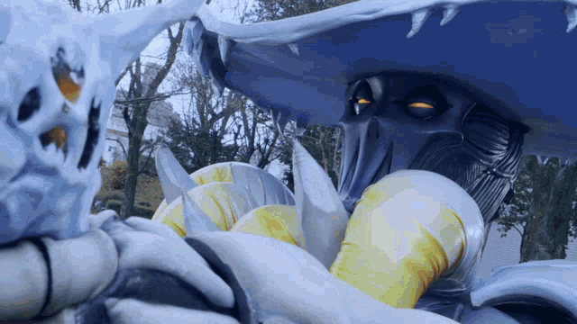 a statue of a monster with yellow eyes and a huge mouth