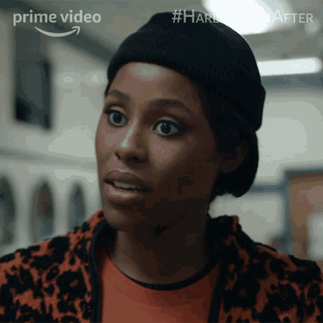 a woman is wearing a black beanie and a leopard print jacket with the words prime video on the bottom