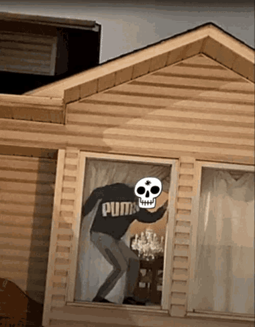 a man with a skull on his face is wearing a puma sweater