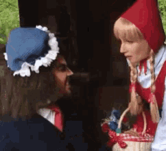 a little red riding hood is talking to a man