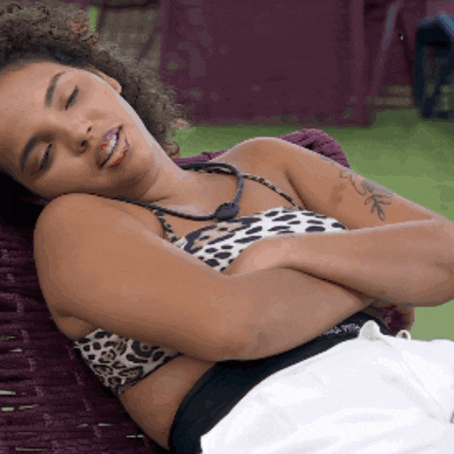 a woman with a tattoo on her arm is laying down
