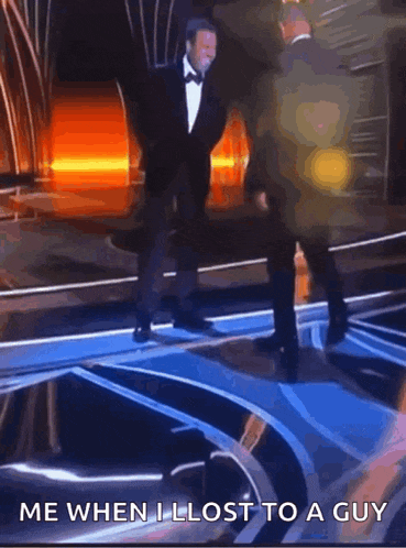 a man in a tuxedo is dancing on a stage with the caption " me when i lost to a guy " .