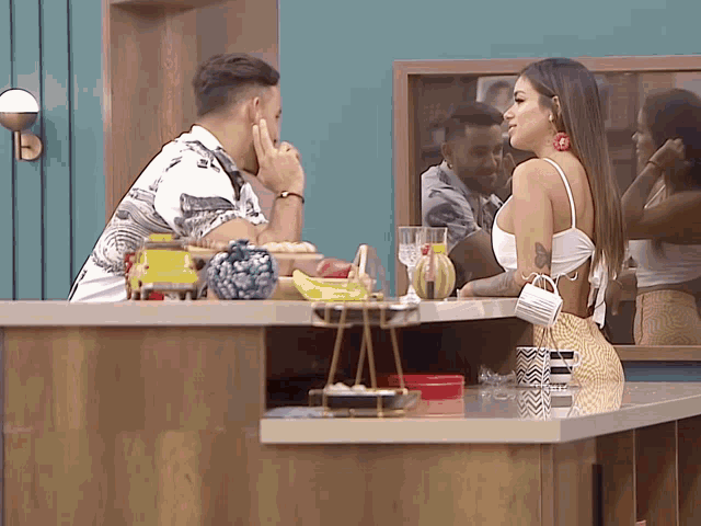 a man and a woman are sitting at a counter