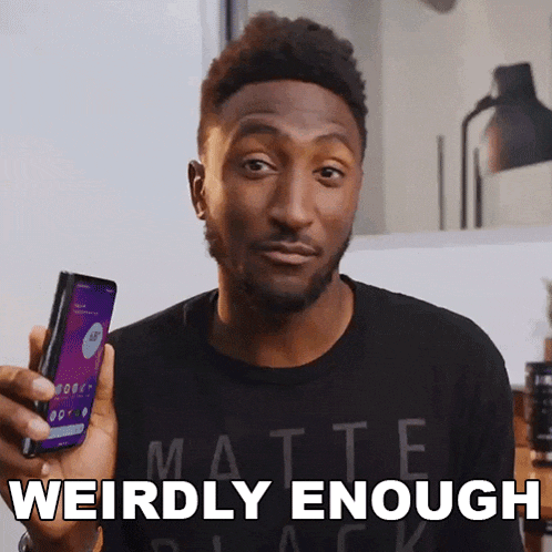 a man wearing a black shirt that says matte black is holding a cell phone and says weirdly enough