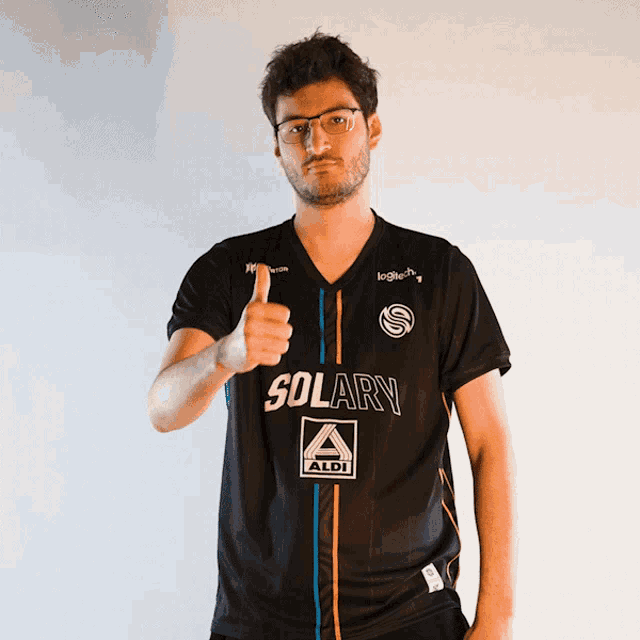 a man giving a thumbs up in a solary shirt