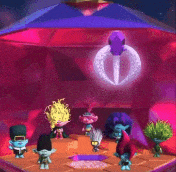 a group of trolls are standing in a room in front of a pyramid .