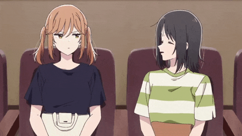 two anime girls are sitting next to each other in a row