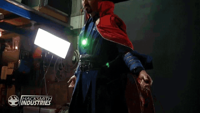 a man in a doctor strange costume is standing in front of a sign for hacksmith industries