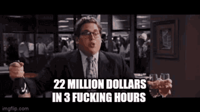 a man in a suit and tie is holding a glass of whiskey and saying `` 22 million dollars in 3 fucking hours ''