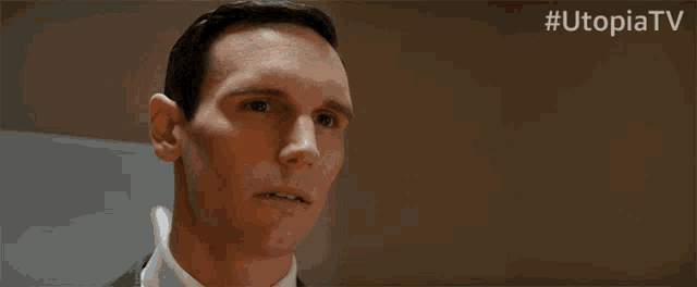 a close up of a man 's face with the hashtag utopiatv on the bottom right