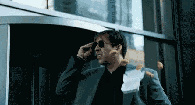 a man in a suit talking on a cell phone