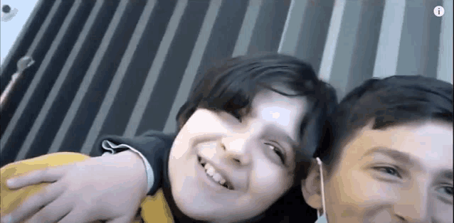 a boy and a girl are posing for a picture together .