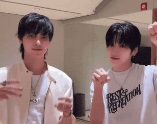 two young men are standing next to each other with one wearing a shirt that says rest & recreation