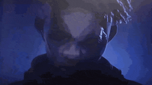 a close up of a man 's face in a dark room .