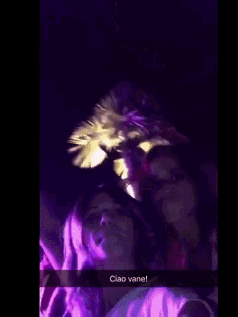 a group of people are dancing in a dark room and a snapchat says ciao vane !