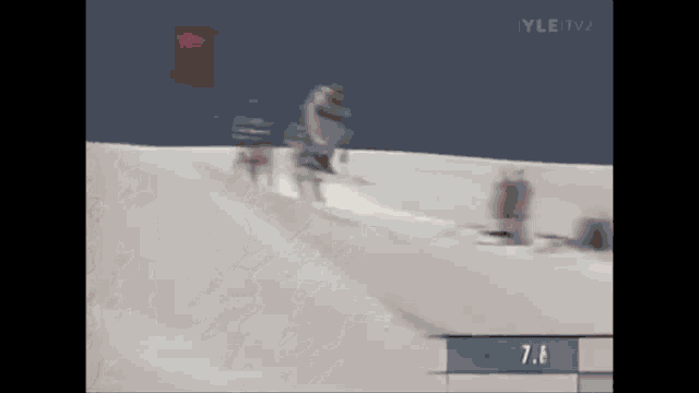 a person skiing down a snowy hill with the number 8.6 on the bottom right