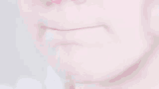 a close up of a woman 's mouth with red lipstick .