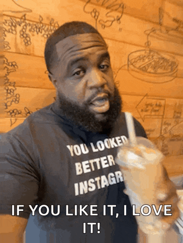 a man wearing a shirt that says " you looked better instagr " drinks a milkshake