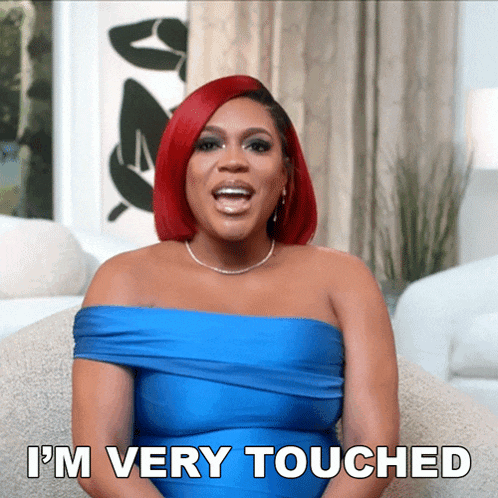a woman with red hair and a blue dress says i 'm very touched