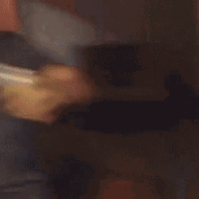 a man in a blue shirt is holding a glass and a can of soda