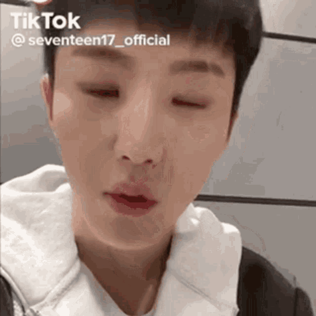 a close up of a person 's face with their eyes closed and their mouth open .