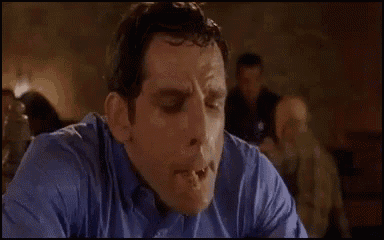a man in a blue shirt is making a funny face .