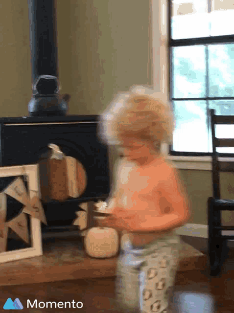 a blurry picture of a child in a room with the word momento on the bottom