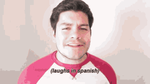 a man is laughing in spanish and making a funny face .