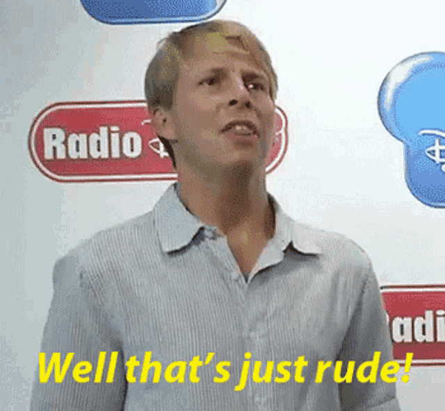 a man stands in front of a sign that says radio well that 's just rude
